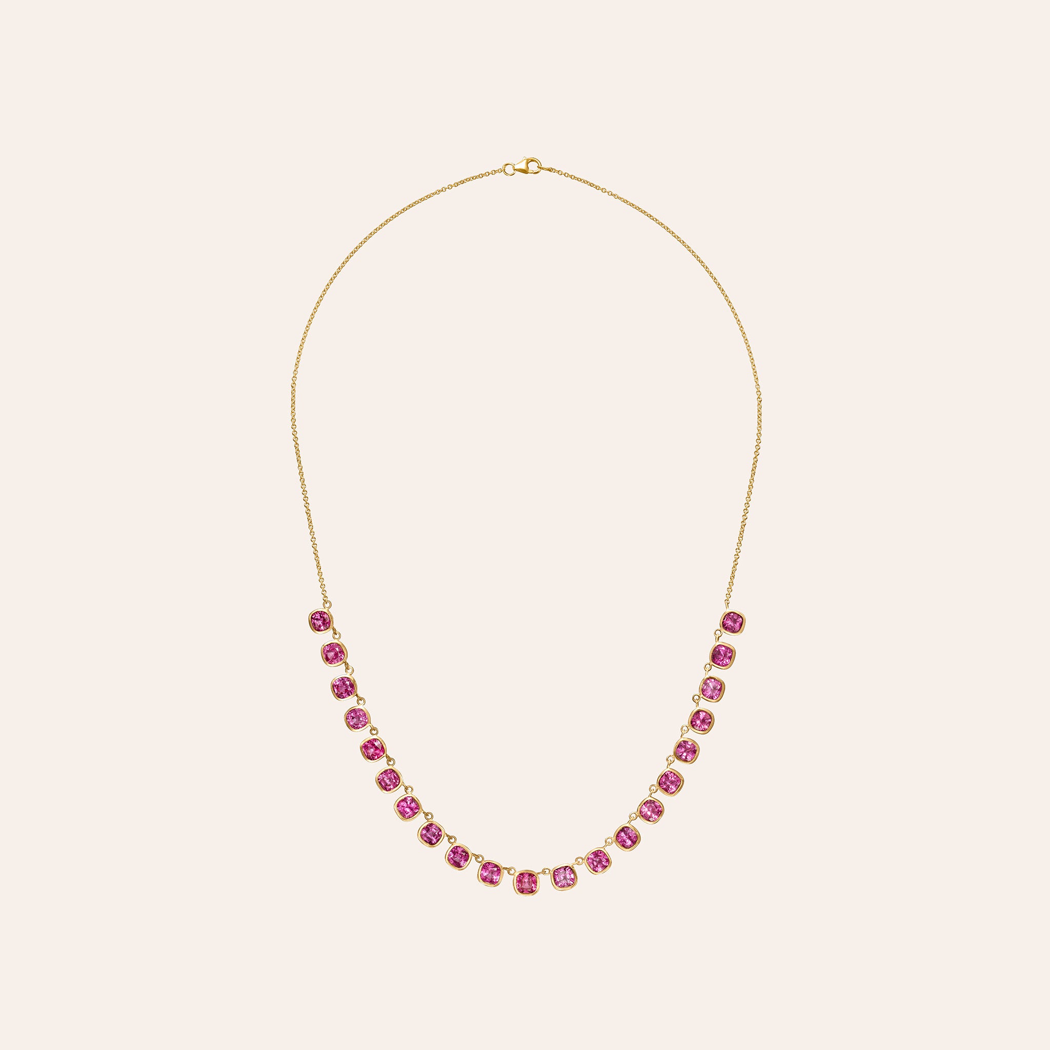 Full-length view of an 18K gold pink sapphire necklace with lobster clasp, showing adjustable 15–16" chain.