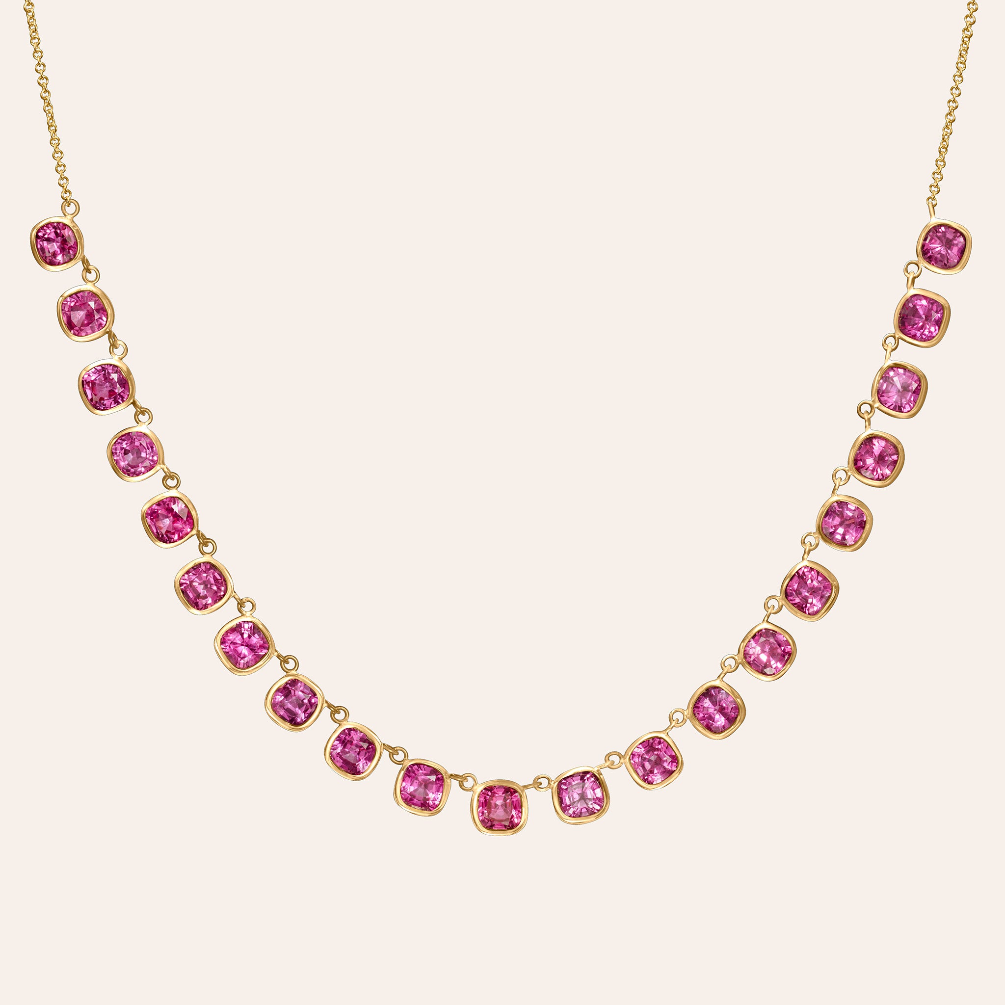 18K gold necklace with 21 graduated bezel-set pink sapphires forming a fringe along a fine cable chain.