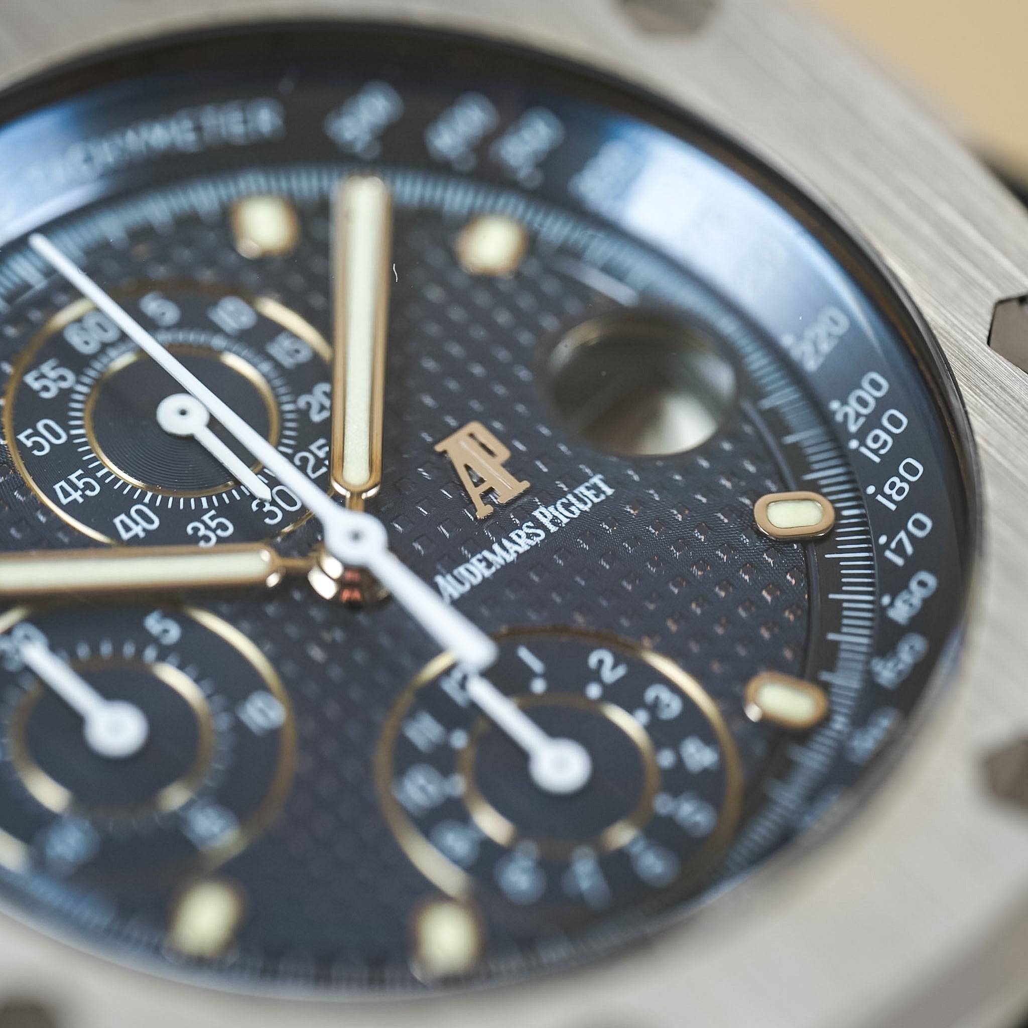 Close-up of a luxurious watch face with detailed design and brand logo.