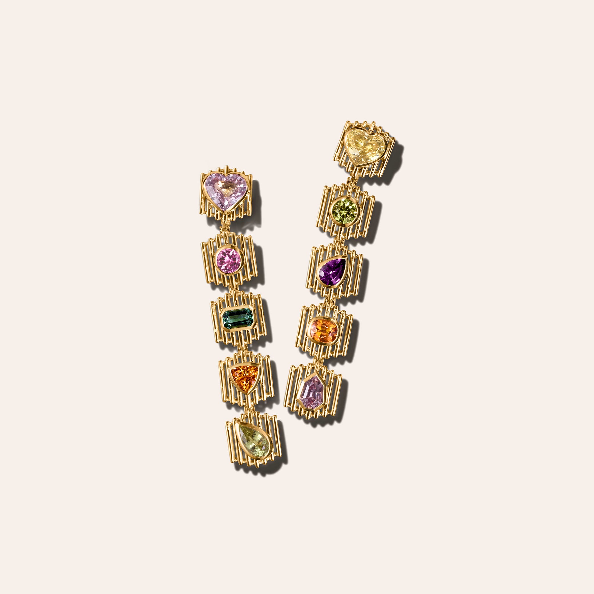The Silhouette Suite drop earrings in 18kt yellow gold with sapphire, tourmaline, spinel, and garnet in heart, pear, trillion, and emerald cuts