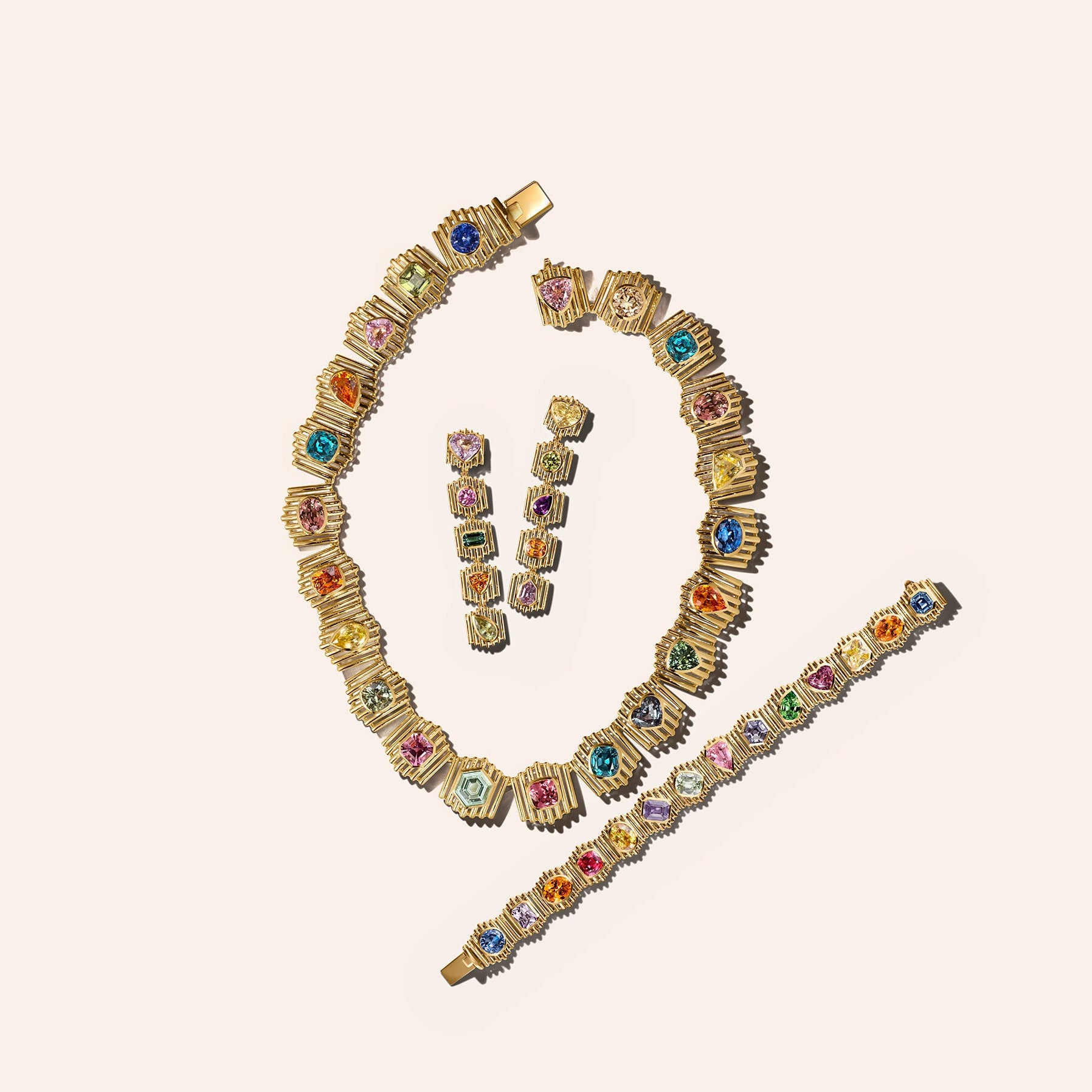 The Silhouette Suite in 18kt yellow gold, including a necklace, bracelet, and drop earrings set with multicolor sapphires, tourmaline, and garnet