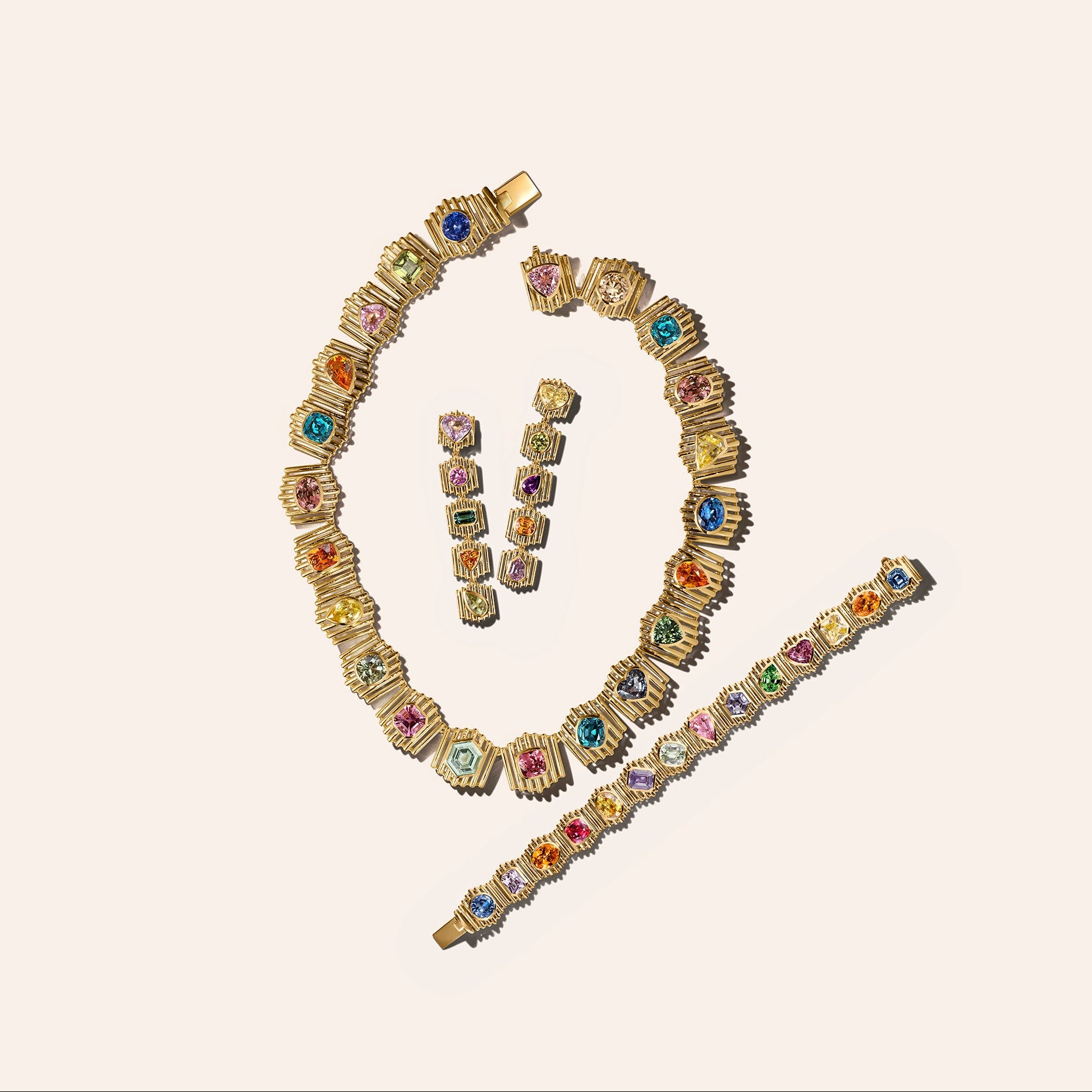 The Silhouette Suite in 18kt yellow gold, including a necklace, bracelet, and drop earrings set with multicolor sapphires, tourmaline, and garnet