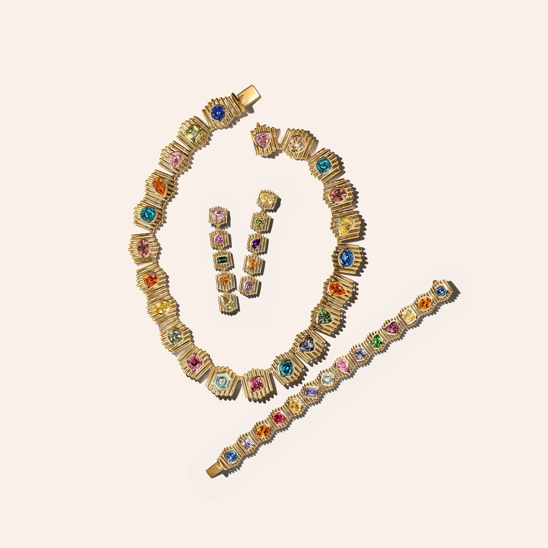 The Silhouette Suite in 18kt yellow gold, including a necklace, bracelet, and drop earrings set with multicolor sapphires, tourmaline, and garnet.