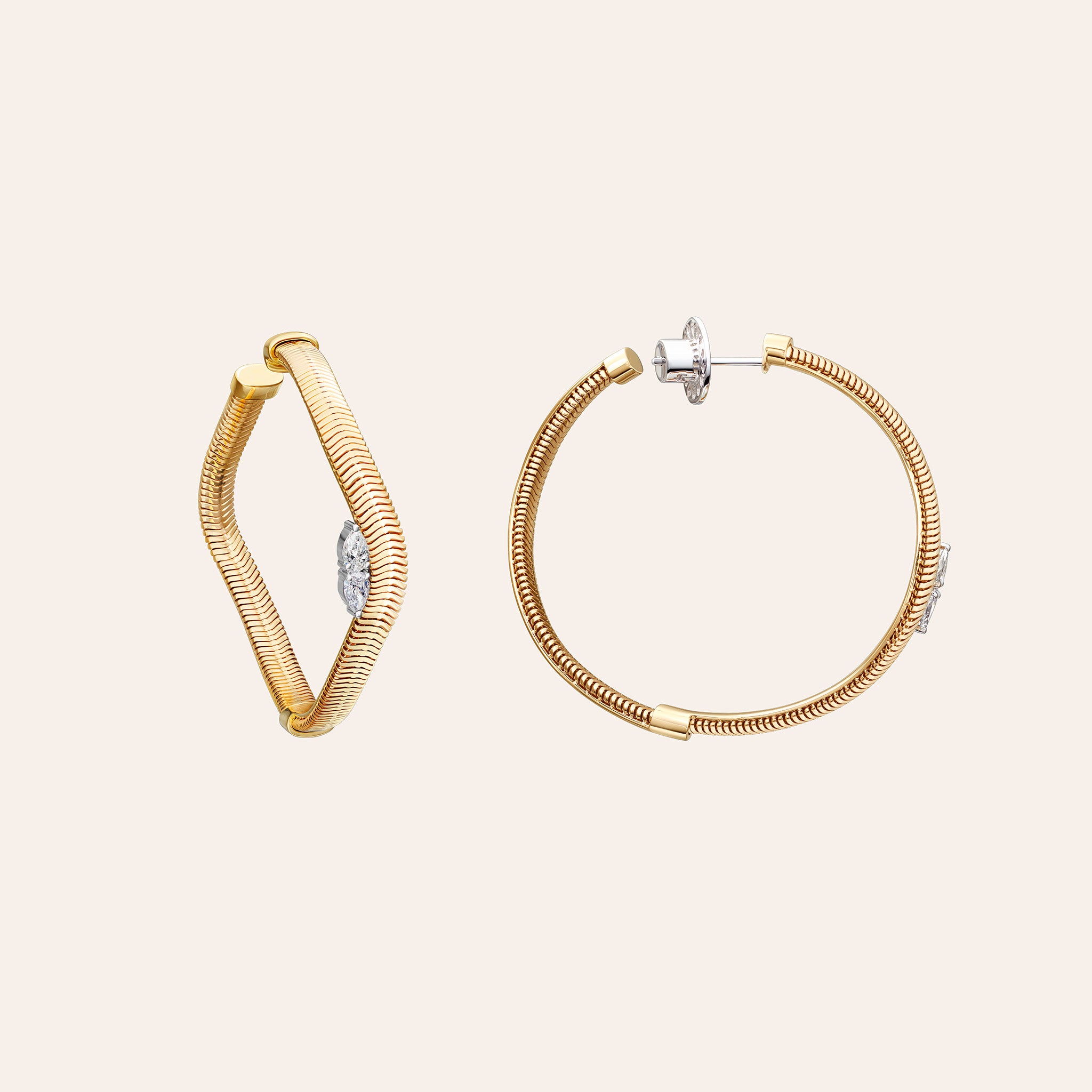 Alternate view of the Nikos Koulis Feelings Chain & Diamond Hoop Earrings in 18K yellow gold, showing pear-shaped diamonds and snake chain detailing, against a cream background.