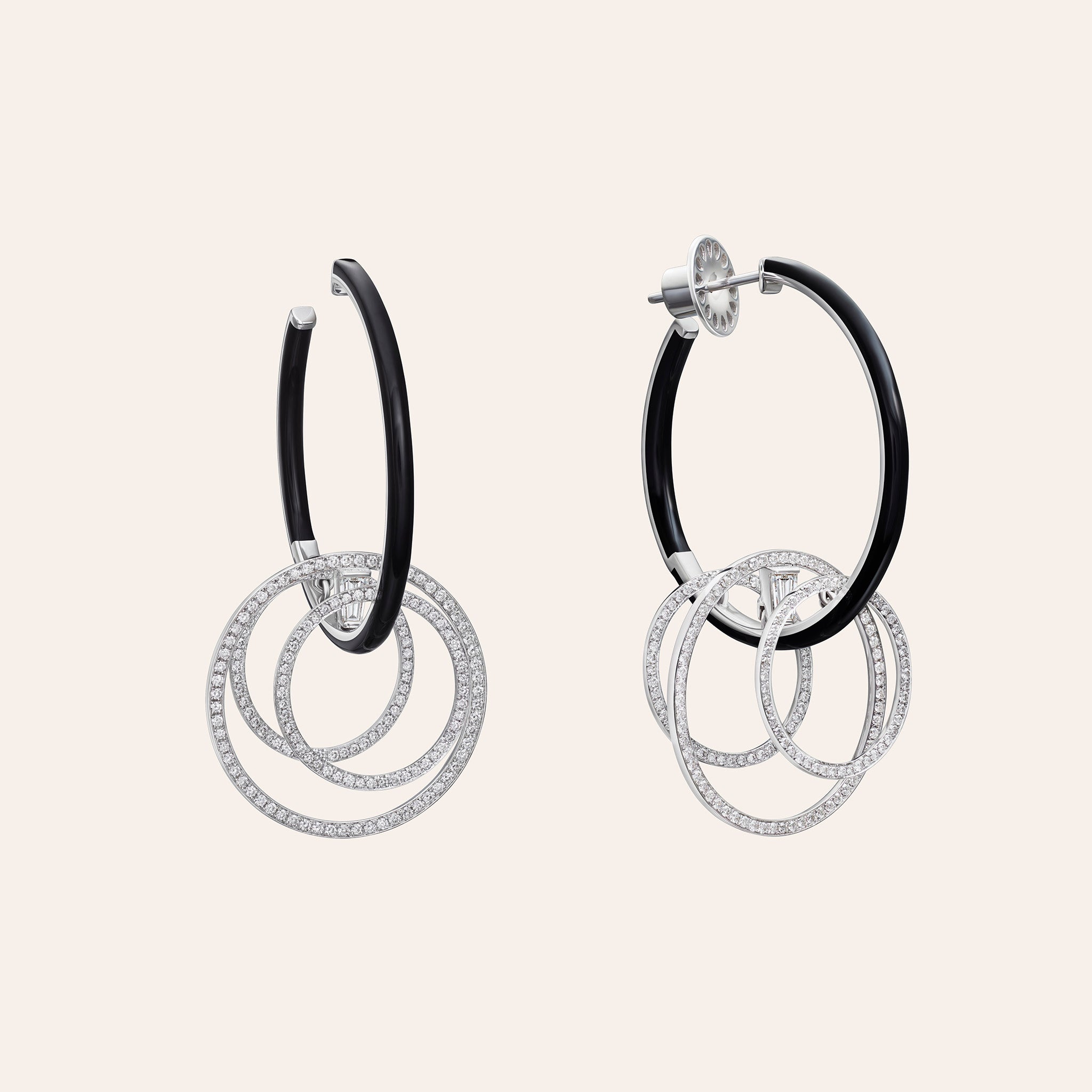 Alternate view of the Nikos Koulis Oui Diamond & Black Enamel Hoops in 18K white gold, showing baguette and round brilliant diamonds with black enamel, against a cream background.