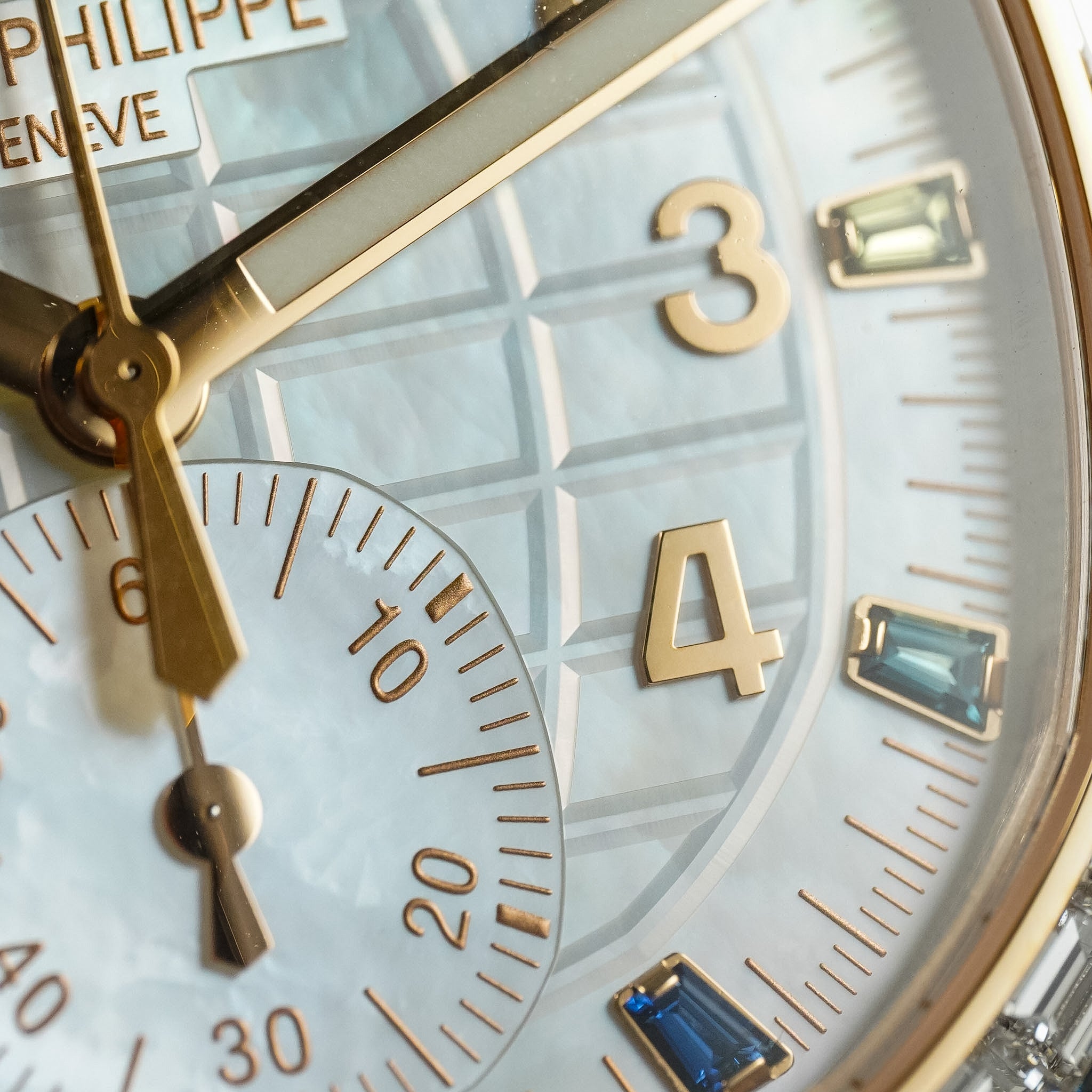 Close-up of a luxury watch face with gold and blue accents