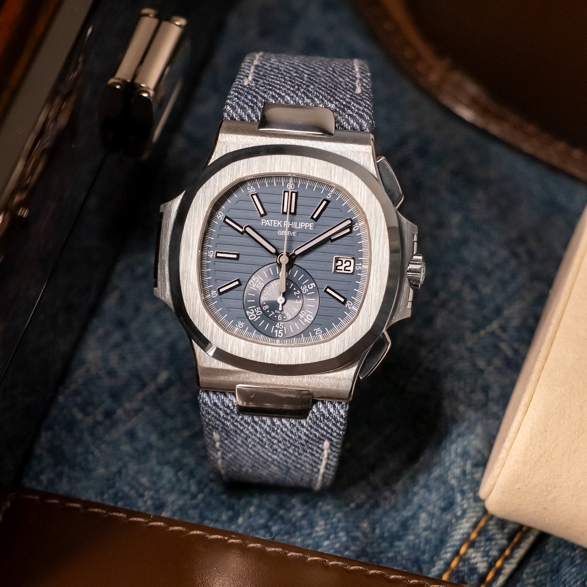 Luxury watch with blue strap on denim fabric