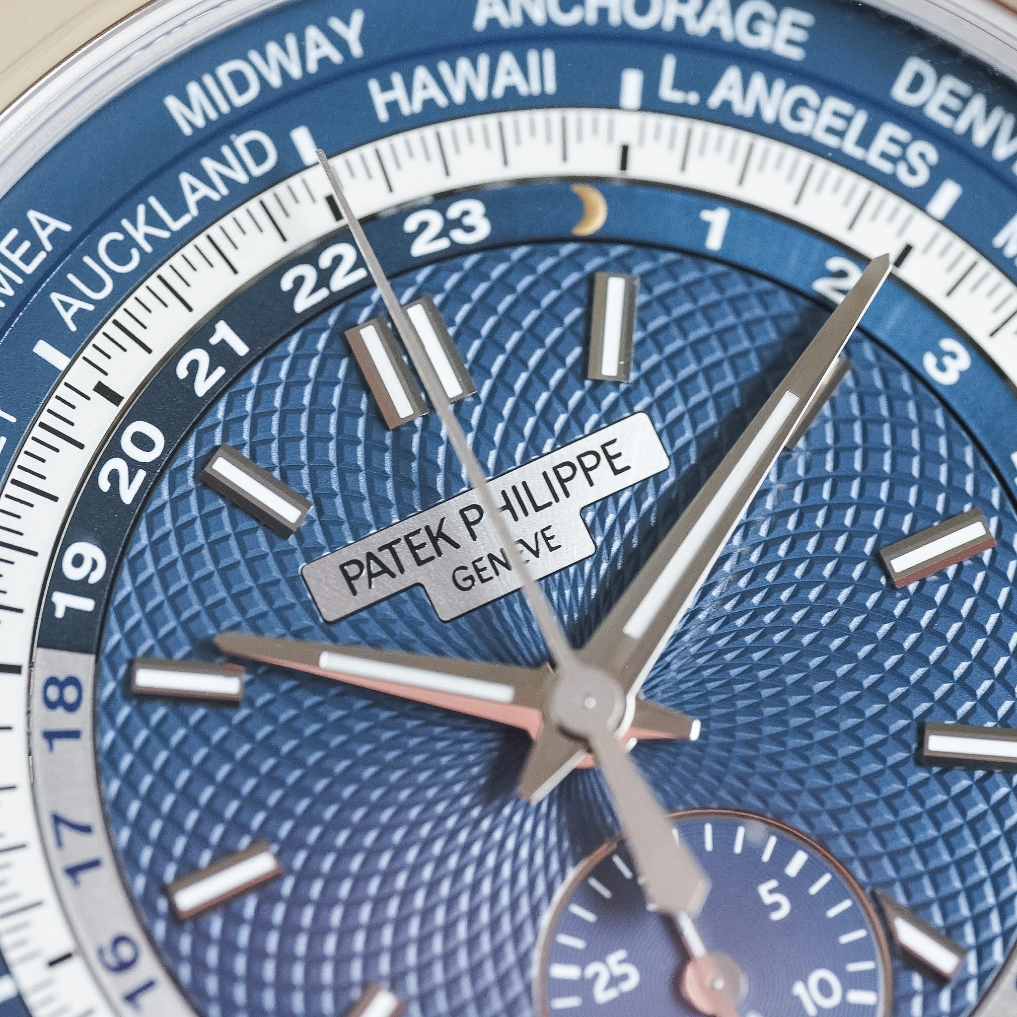Close-up of a Patek Philippe watch face with blue and white design