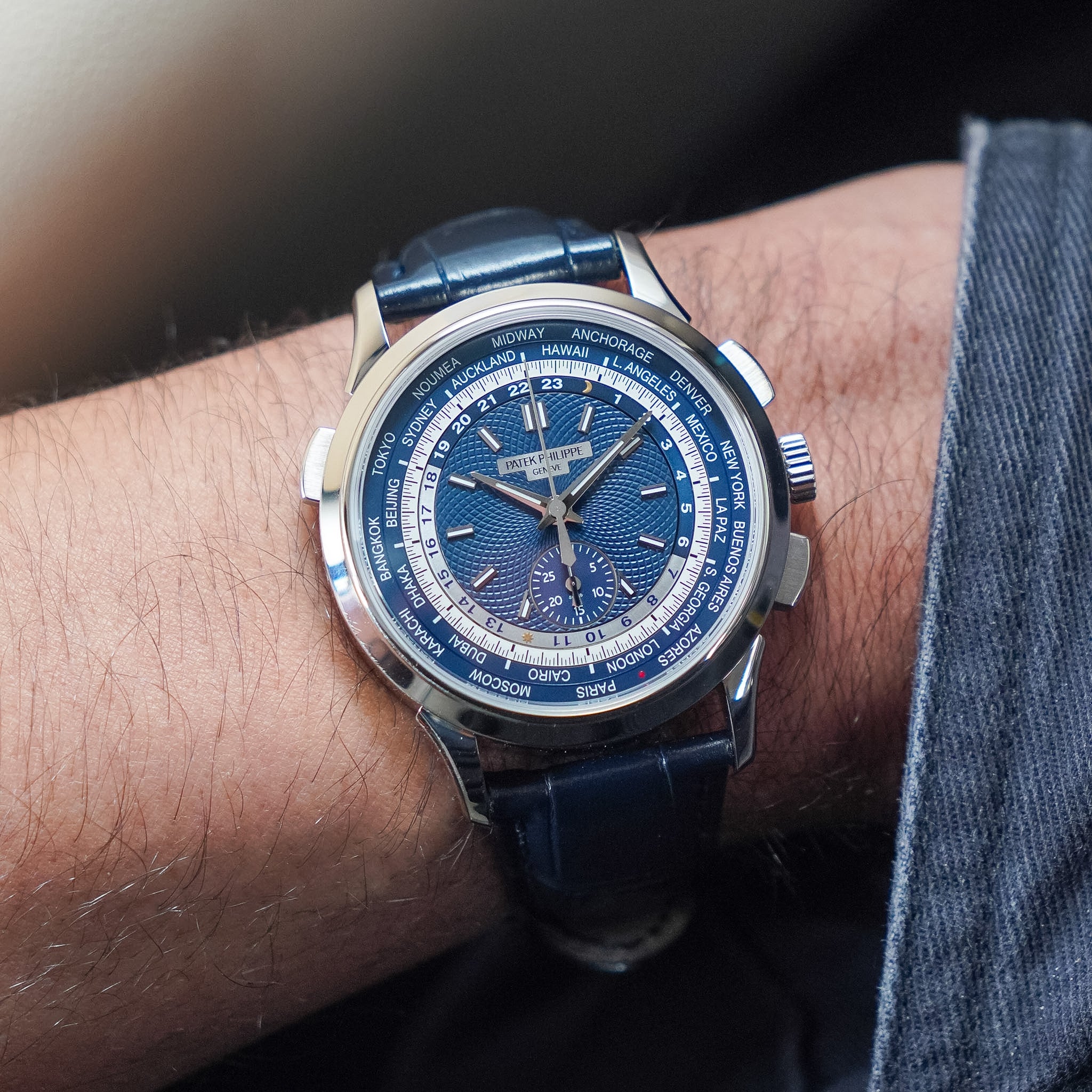 Blue wristwatch with detailed face on a person's wrist