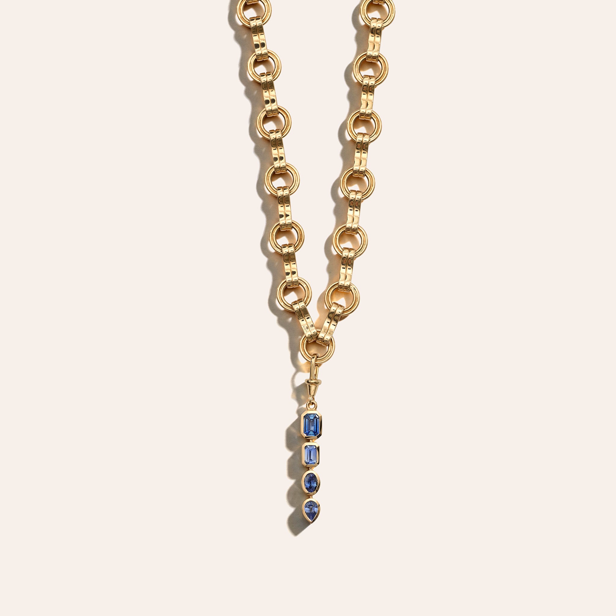 AZLEE Gradient Sapphire Lariat Charm in 18K yellow gold, a lariat-style drop of Madagascar sapphires in a color gradient on a watch fob clasp on motif chain