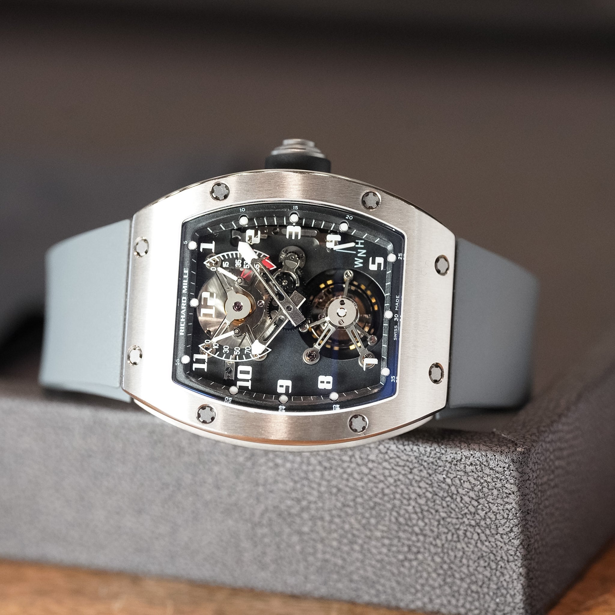 Luxury watch with a detailed face on a gray cushion