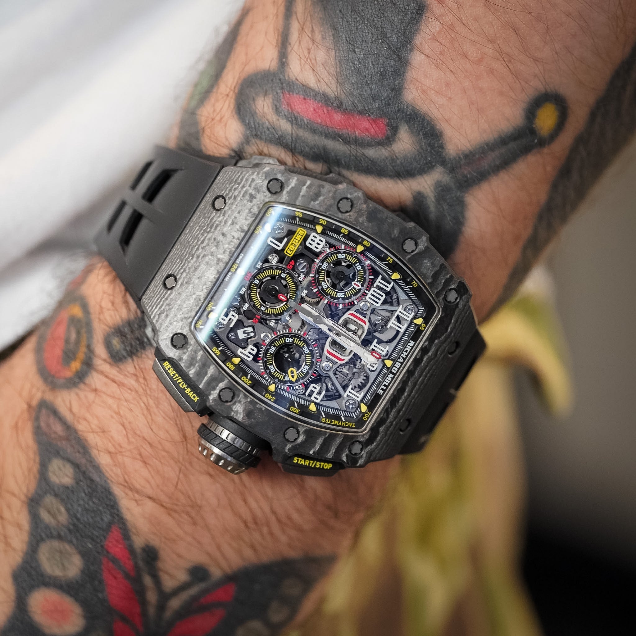 Luxury watch on a wrist with tattoos
