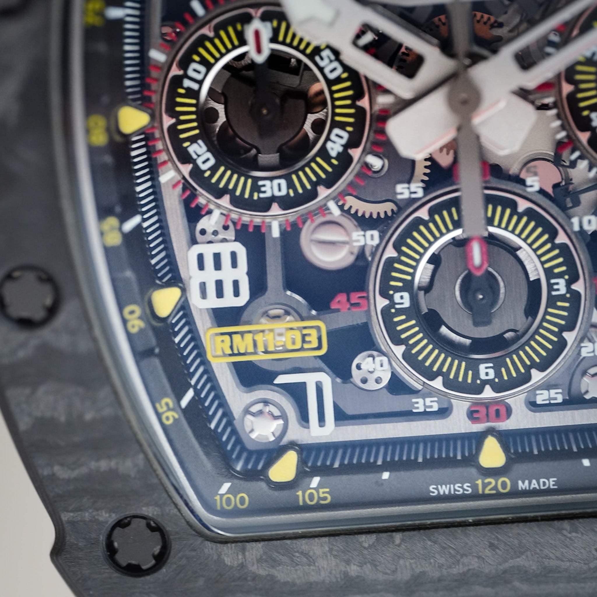 Close-up of a detailed watch face with visible brand and model information.