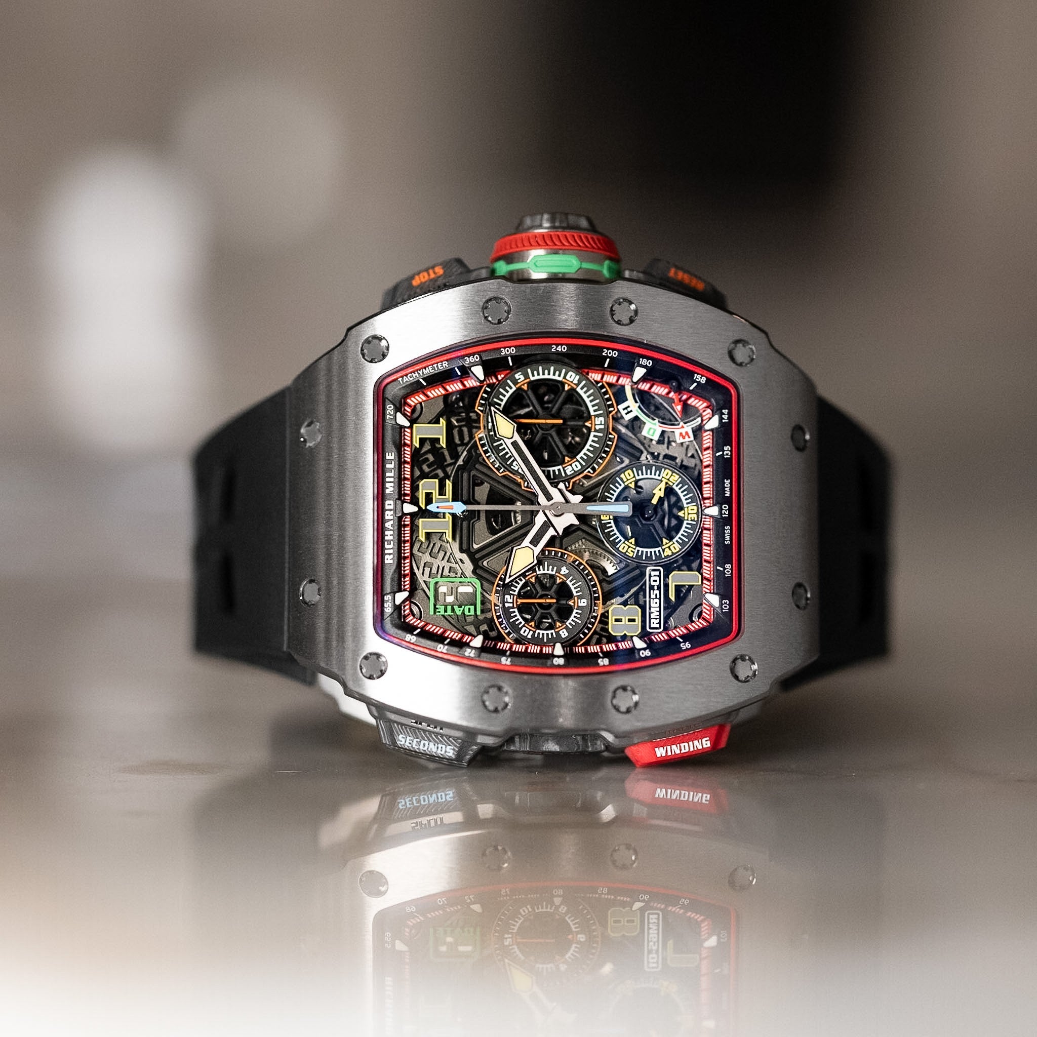 Luxury watch with intricate design on a reflective surface