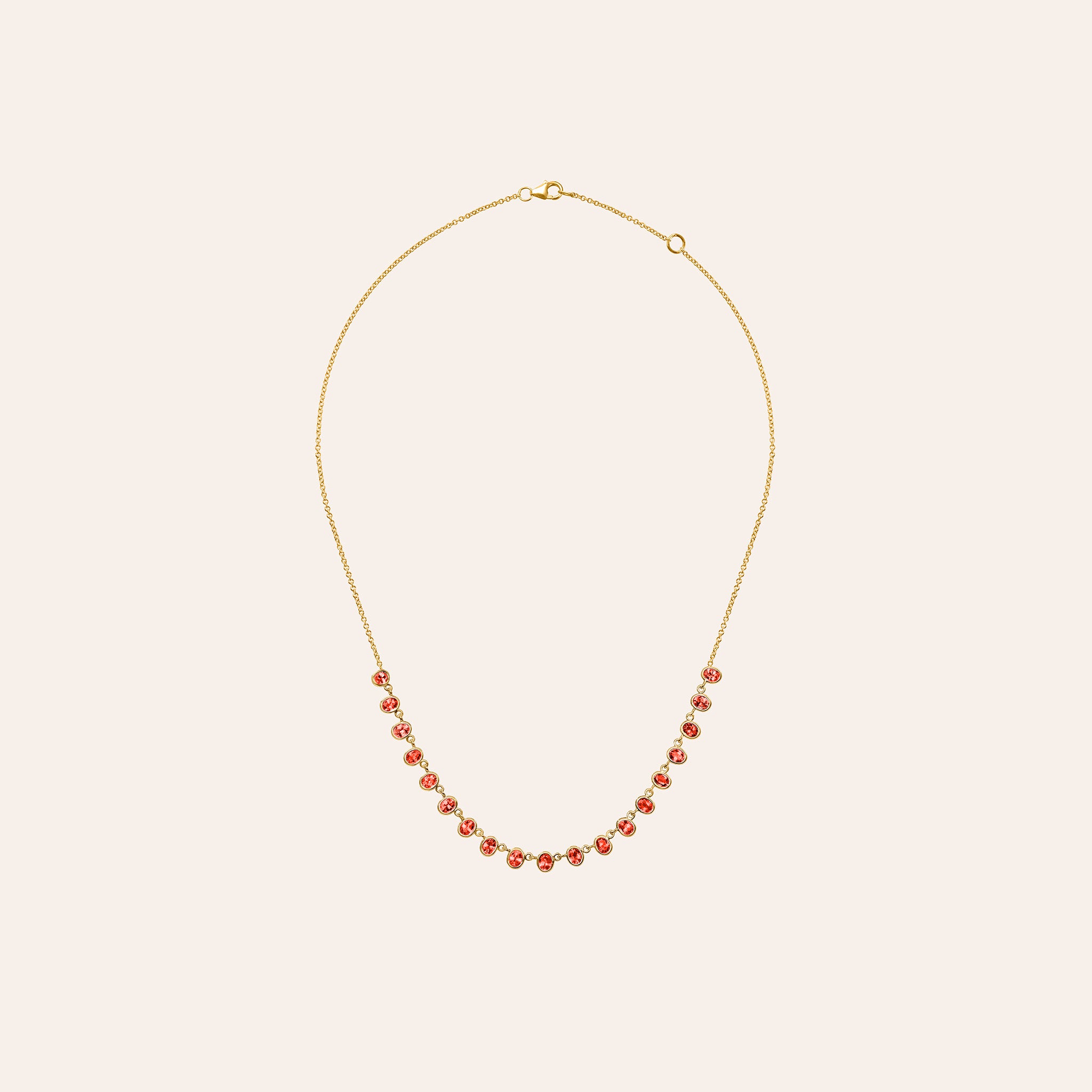 18K yellow gold necklace with seven bezel-set oval orange sapphires (total 4.42 ct), adjustable 15–15.5″ chain in a delicate fringe style. 