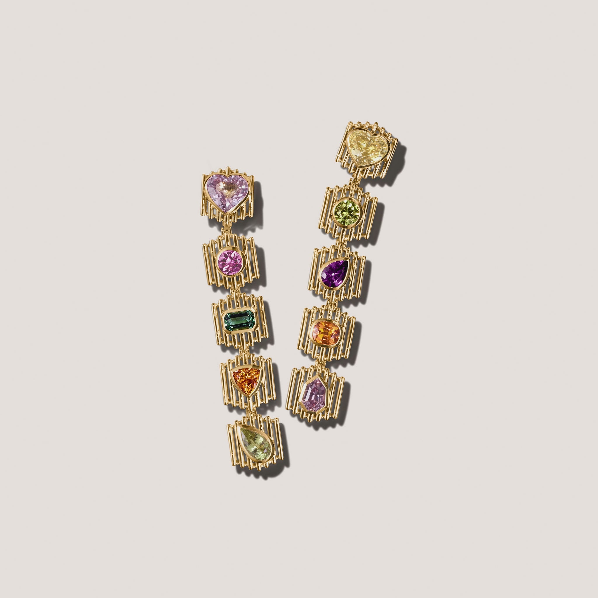 The Silhouette Suite drop earrings in 18kt yellow gold with sapphire, tourmaline, spinel, and garnet in heart, pear, trillion, and emerald cuts video of stud attaching and detaching 